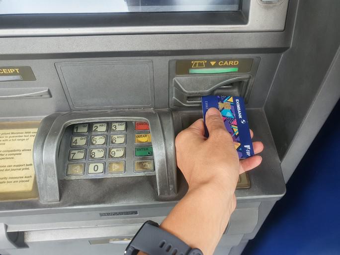 Người dân rút tiền mặt qua máy ATM giảm rất mạnh - 1