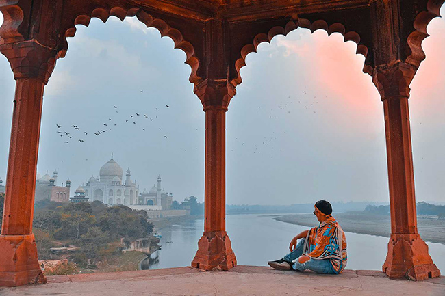 Bức ảnh xuyên qua vòm, phóng tầm mắt ra xa để thấy toàn bộ kiến ​​trúc chính của Taj Mahal là một góc chụp cực kỳ kinh điển của bất kỳ nhiếp ảnh gia nào khi đến thăm kỳ quan này.
