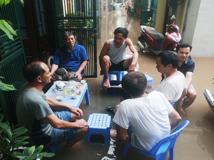 Hình ảnh lạ ở Hà Nội: Người dân kê bàn uống trà giữa dòng nước