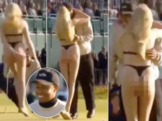 Blushing Tiger Woods was forced to kiss by a bikini beauty during the competition